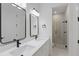 Modern bathroom with double sinks, matte black fixtures, and a glass enclosed shower at 355 Anderson Dr, Groveland, FL 34736