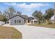 Exterior view of this single-Gathering home showing its new concrete driveway and stylish facade at 355 Anderson Dr, Groveland, FL 34736