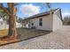 Side view of this single-Gathering home showing gravel yard, and porch at 355 Anderson Dr, Groveland, FL 34736