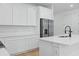 Contemporary kitchen with white cabinetry, stainless steel appliances, and a center island with a black faucet at 355 Anderson Dr, Groveland, FL 34736