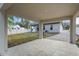 The covered patio looks out onto the back of the house and the carport at 355 Anderson Dr, Groveland, FL 34736