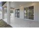 The covered patio features recessed lights and large glass sliding doors at 355 Anderson Dr, Groveland, FL 34736