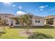 Back of home with covered patio and well-manicured lawn at 362 Sofia Ln, Lake Alfred, FL 33850