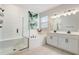 Clean bathroom featuring tile floors, double sink vanity, garden tub and glass shower at 362 Sofia Ln, Lake Alfred, FL 33850