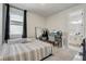 Well-lit bedroom with carpet flooring, a large window, and views into the adjoining bathroom at 362 Sofia Ln, Lake Alfred, FL 33850