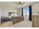 Calm bedroom with soft carpet, a large bed with a blue blanket and modern gray curtains at 362 Sofia Ln, Lake Alfred, FL 33850