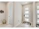 Clean entryway with tile floors, decorative mirror, and a modern front door with glass panels at 362 Sofia Ln, Lake Alfred, FL 33850