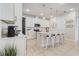 Modern kitchen with sleek white cabinetry, a center island, and pendant lighting at 362 Sofia Ln, Lake Alfred, FL 33850