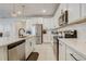 Well-equipped kitchen showcases stainless steel appliances, white cabinets, quartz counters, and stylish backsplash at 362 Sofia Ln, Lake Alfred, FL 33850