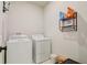 Functional laundry room with washer, dryer, and storage shelves at 362 Sofia Ln, Lake Alfred, FL 33850