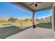 Covered patio with ceiling fan overlooking backyard with adjacent homes and a walking path nearby at 362 Sofia Ln, Lake Alfred, FL 33850