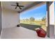 Covered patio with ceiling fan offering a peaceful outdoor retreat with a view of the green lawn at 362 Sofia Ln, Lake Alfred, FL 33850