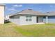 Exterior of home with slider door to backyard and green grass at 3762 Sungrove Cir, Sanford, FL 32771