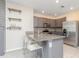 Well-lit kitchen showcasing granite countertops, stainless steel appliances, and tiled floors at 3762 Sungrove Cir, Sanford, FL 32771