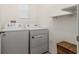 Bright laundry room with white washer and dryer, shelf and basket at 3762 Sungrove Cir, Sanford, FL 32771