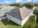 Aerial view highlighting the home's roof, patio, and landscaping in a tranquil setting at 4087 Clock Tower Dr, Port Orange, FL 32129