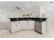 Bright kitchen with white cabinets, black countertops, and stainless steel dishwasher at 4087 Clock Tower Dr, Port Orange, FL 32129