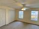 This is a bedroom with two windows, carpet and a ceiling fan with lighting at 435 Pleasant St, Lake Helen, FL 32744