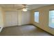 This bedroom features neutral walls, carpet and dual closets, as well as a ceiling fan at 435 Pleasant St, Lake Helen, FL 32744