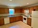 Bright kitchen featuring wood cabinets, modern appliances, and tile flooring at 435 Pleasant St, Lake Helen, FL 32744