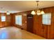 This living room has wooden walls, vinyl flooring, and a chandelier at 435 Pleasant St, Lake Helen, FL 32744