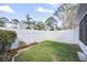 Well-maintained backyard featuring a white fence, landscaping, and green grass at 483 Green Spring Cir, Winter Springs, FL 32708