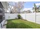 A view of the spacious backyard with a white vinyl fence and some colorful landscaping at 483 Green Spring Cir, Winter Springs, FL 32708