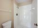 Bathroom with toilet and white tiled shower stall and bronze fixtures at 483 Green Spring Cir, Winter Springs, FL 32708