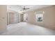 Spacious bedroom with neutral carpet, ceiling fan, double closet doors and window at 483 Green Spring Cir, Winter Springs, FL 32708