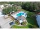 Aerial view of the community pool with lounge chairs and a bath house at 483 Green Spring Cir, Winter Springs, FL 32708