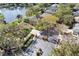 Aerial view of homes in a gated community, featuring lush landscaping, a tranquil lake, and mature trees at 490 Wekiva Preserve Dr, Apopka, FL 32712