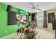 Bedroom designed as a music room, with an electric guitar and neon 'Drums' sign on a green wall at 490 Wekiva Preserve Dr, Apopka, FL 32712