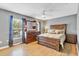 Bedroom showcasing hardwood floors, a ceiling fan, and natural light at 490 Wekiva Preserve Dr, Apopka, FL 32712