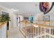 Hallway featuring wood and white banister with views of the downstairs living area at 490 Wekiva Preserve Dr, Apopka, FL 32712