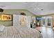 An airy main bedroom with french doors to the ensuite bathroom and a balcony with seating area at 490 Wekiva Preserve Dr, Apopka, FL 32712