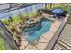 Aerial shot of the pool with spa and beautiful landscaping in screened-in patio at 490 Wekiva Preserve Dr, Apopka, FL 32712