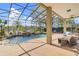 Stunning screened-in pool area with beautiful landscaping, a waterfall, and a view of the lake at 490 Wekiva Preserve Dr, Apopka, FL 32712