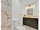 Elegant bathroom featuring marble tile, a modern vanity, and sleek gold fixtures at 5108 Avignon Ct, Orlando, FL 32839