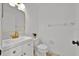 Bright bathroom features a sleek white vanity, modern toilet and fixtures, and clean, minimalist design at 5108 Avignon Ct, Orlando, FL 32839
