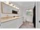 Modern bathroom featuring double sinks, gold hardware, and a large mirror at 5108 Avignon Ct, Orlando, FL 32839