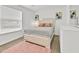 Bright bedroom with a plush bed, light colored wooden floors, and a window at 5108 Avignon Ct, Orlando, FL 32839