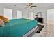 Bright bedroom featuring a ceiling fan, large bed, and a dark dresser at 5108 Avignon Ct, Orlando, FL 32839