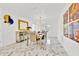 Elegant dining room featuring a modern chandelier, marble floors, and neutral decor at 5108 Avignon Ct, Orlando, FL 32839
