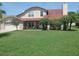 Charming two-story home with a well-manicured lawn and inviting front porch at 5108 Avignon Ct, Orlando, FL 32839