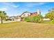 Attractive two-story home with a red roof, a brick front, and lush landscaping in a bright, sunny setting at 5108 Avignon Ct, Orlando, FL 32839