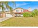 Charming two-story home featuring a brick facade, well-maintained lawn, and a two-car garage at 5108 Avignon Ct, Orlando, FL 32839