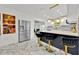 Stylish kitchen with stainless steel fridge, breakfast bar, and marble floors at 5108 Avignon Ct, Orlando, FL 32839