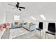 Cozy living area with blue couches, a white rug, skylights and ceiling fan at 5108 Avignon Ct, Orlando, FL 32839