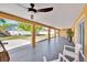 Covered patio featuring white chairs, tile flooring, and a view of the backyard at 5108 Avignon Ct, Orlando, FL 32839