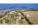 A stunning aerial view showcasing a luxurious waterfront home surrounded by mature trees and lush landscapes at 5150 Banana Point Dr, Okahumpka, FL 34762